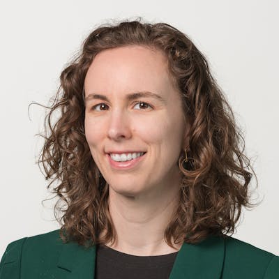 Portrait of Laura Karnath in business casual attire on a white background.