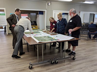 Transportation planning team members reviewing maps of the Sherman and Denison area.